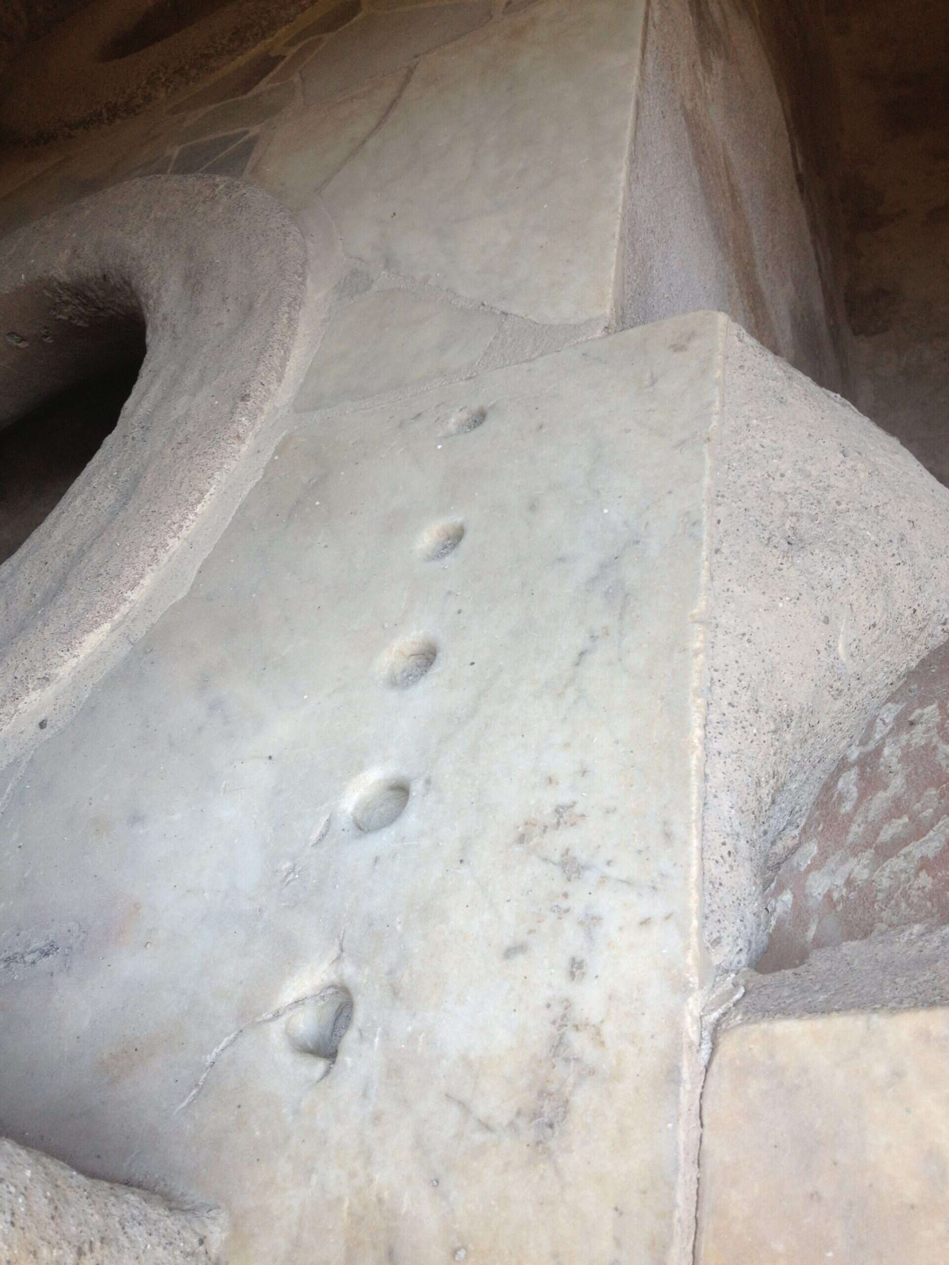 Pompeii merchant counter with holes drilled to measure coins