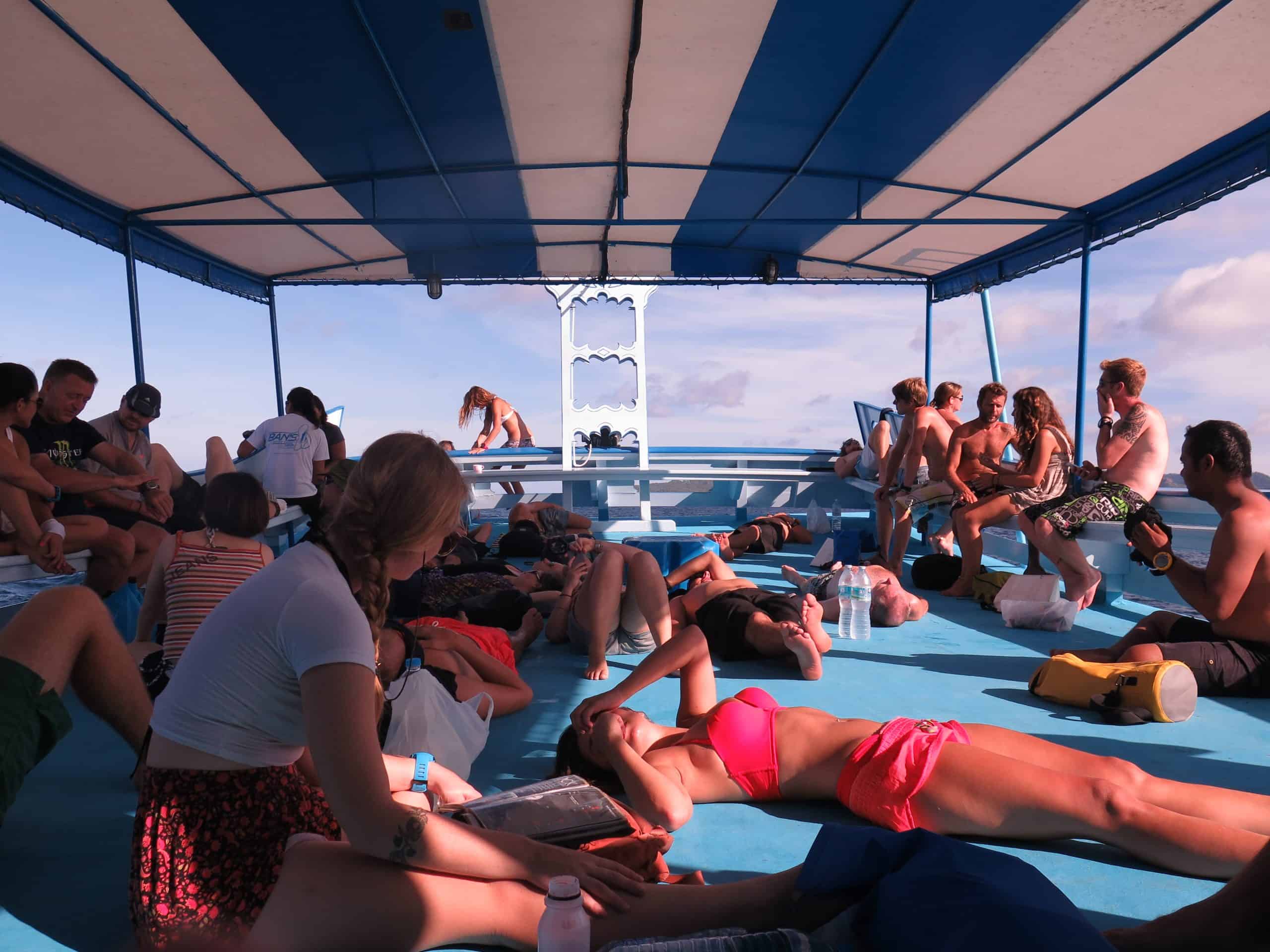 Divemaster students relax on a dive boat between dives in Koh Tao, Thailand.