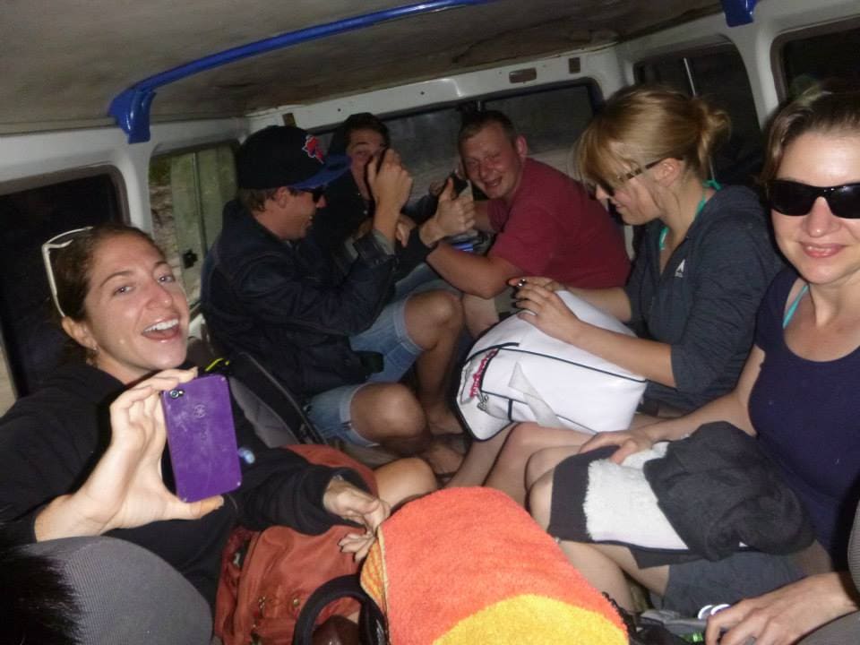 Crowded in the back of a 4x4 jeep while riding on beach on a tour of K'gari island.