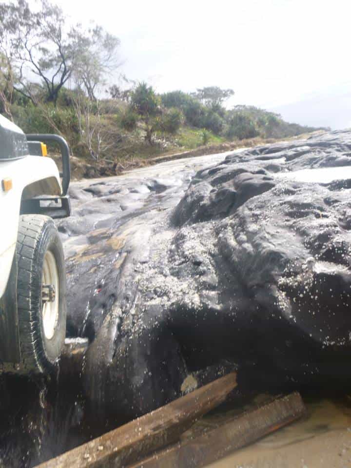 4x4 jeep driving over coffee rock on K'Gari island beaches.
