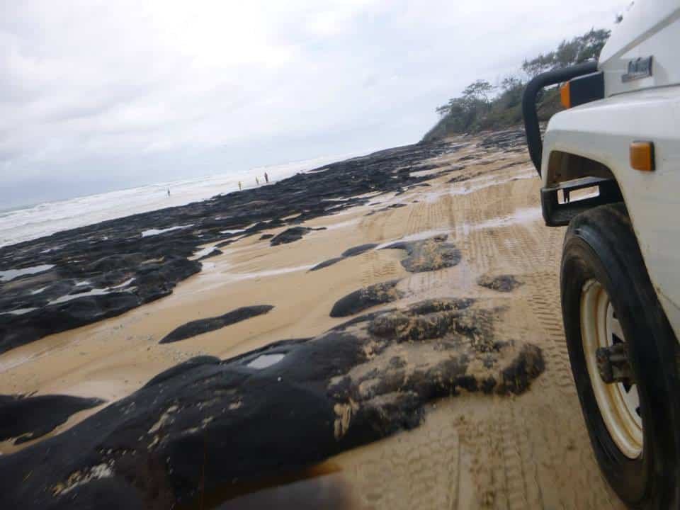 Driving a 4x4 jeep on the beach on K'gari island while on a 3-day tour.