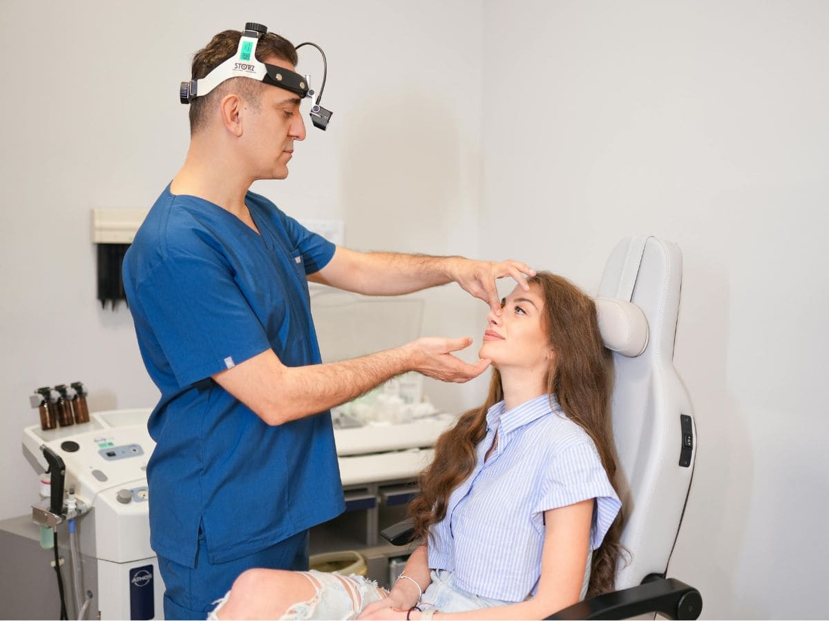 A doctor in Turkey analyzes a young woman's face as part of a medical tourism exam.
