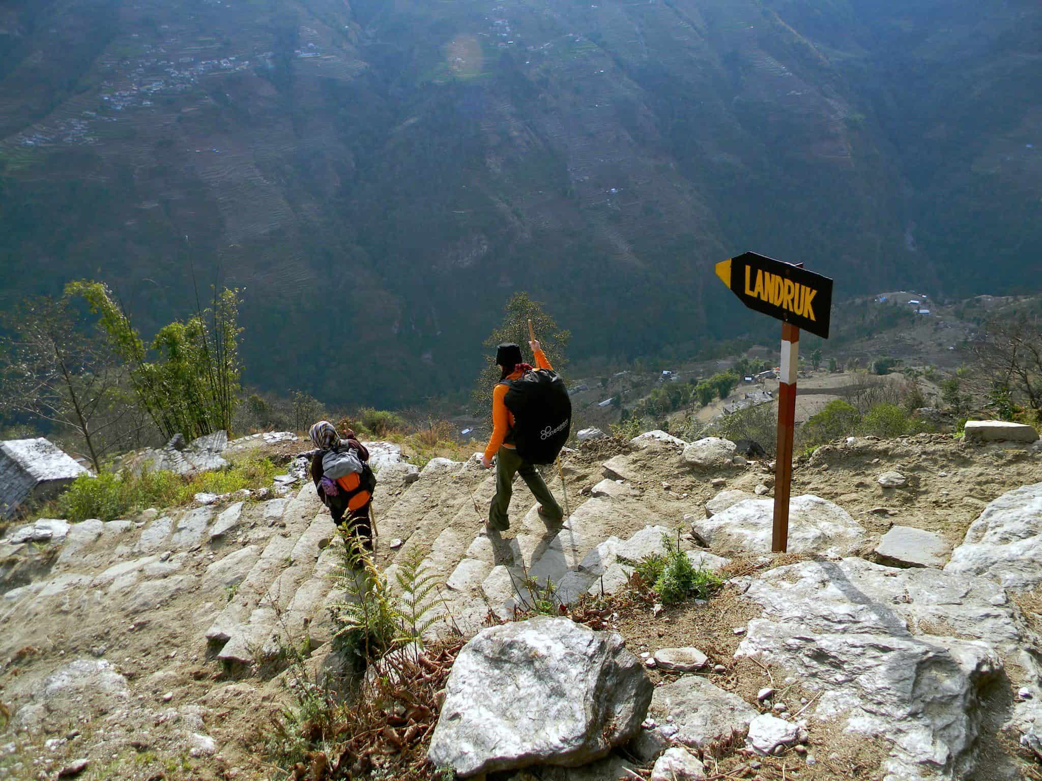 Trekker follows her Nepalese guide on the Annapurna Circuit trail.