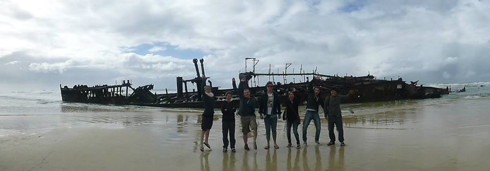 Tour participants in front of the Maheno Shipwreck on 75-mile beach on K'gari island.