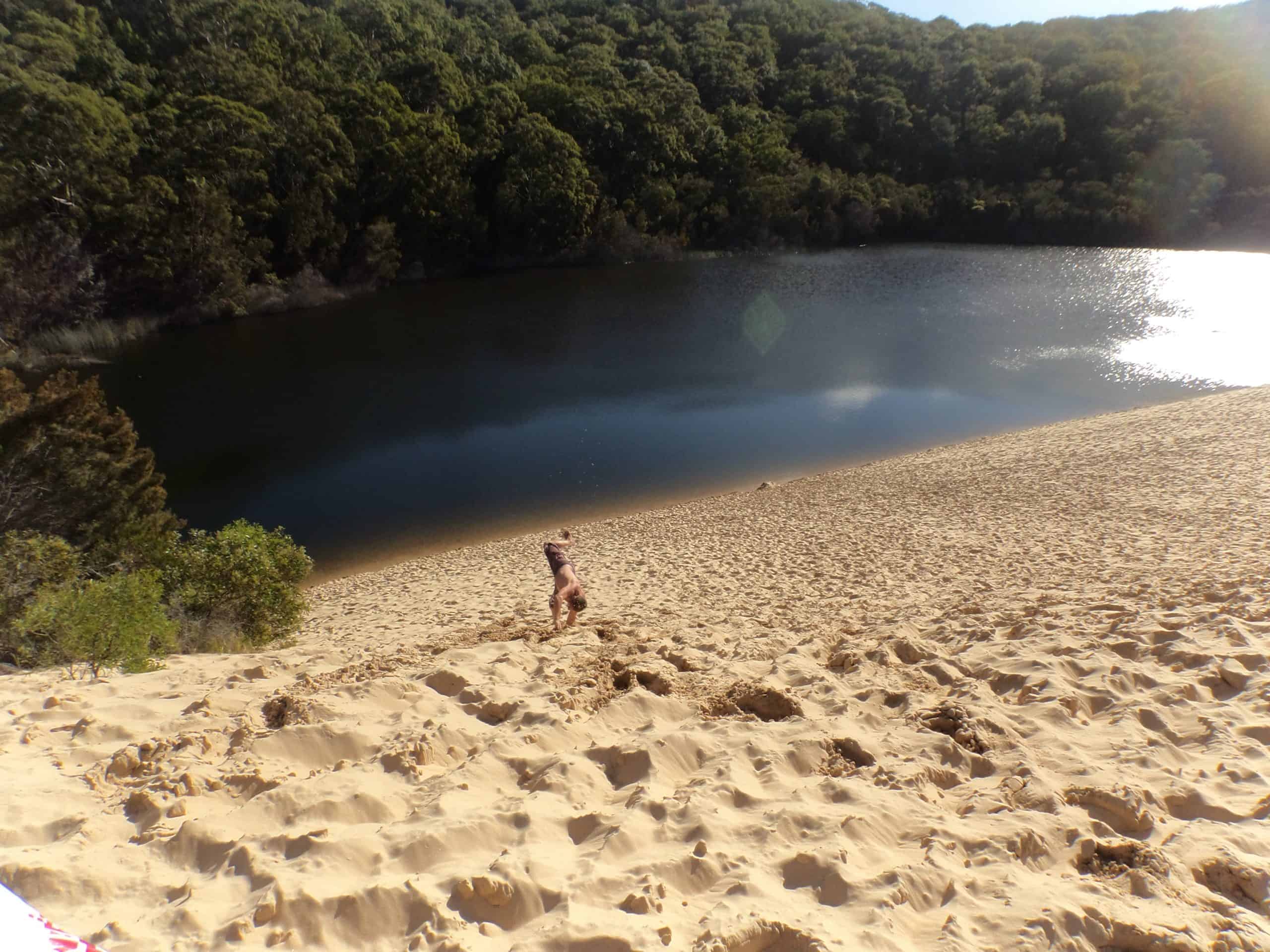 Visitor tumbling towards Lake Wabby on a tour of K'gari Island.