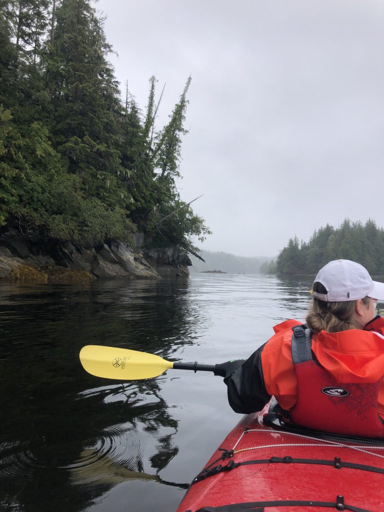 A woman enjoying a kayaking excursion from her Alaskan Cruise.