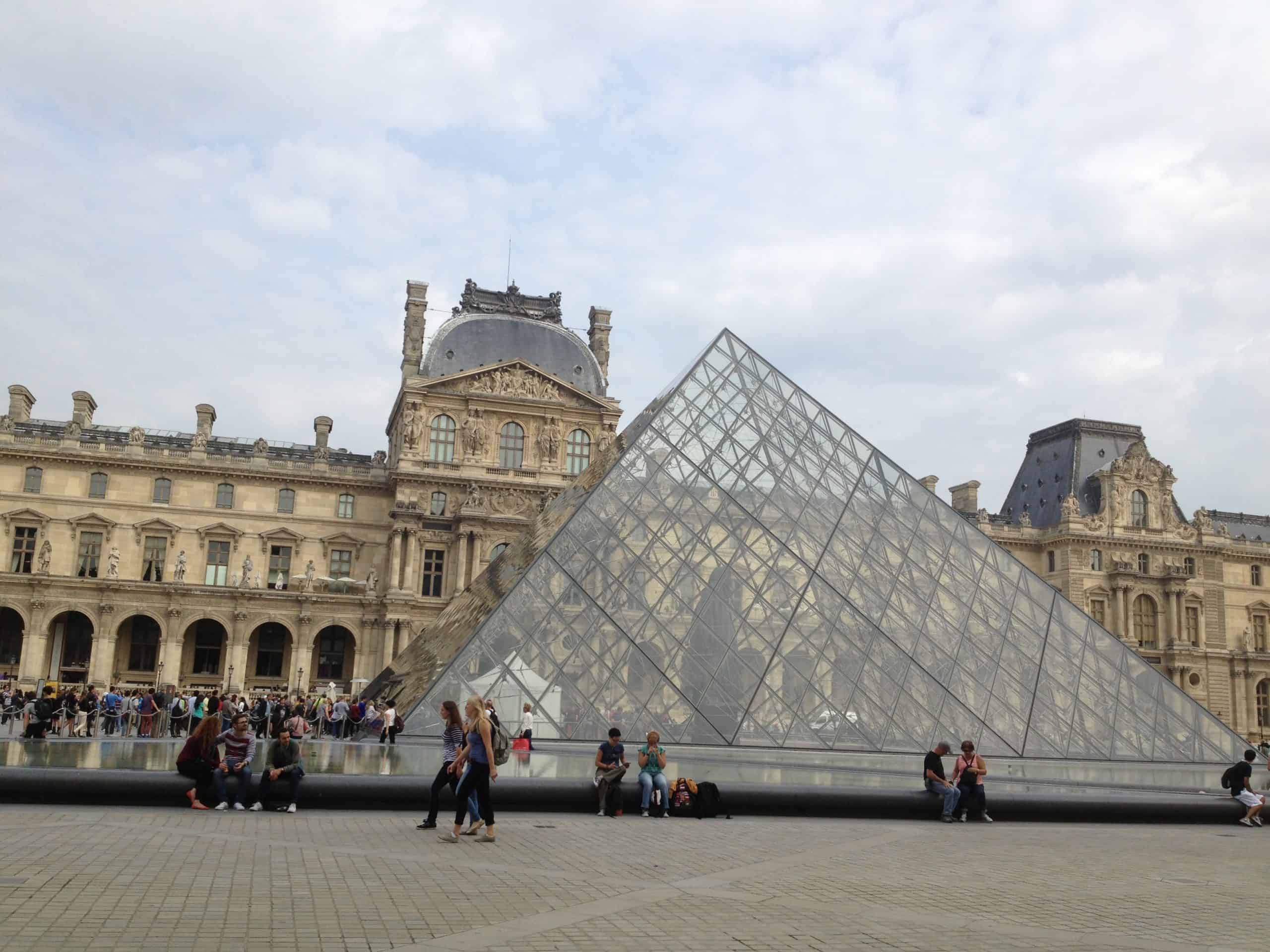 The iconic glass pyramid at the entrance of The Louvre in Paris.