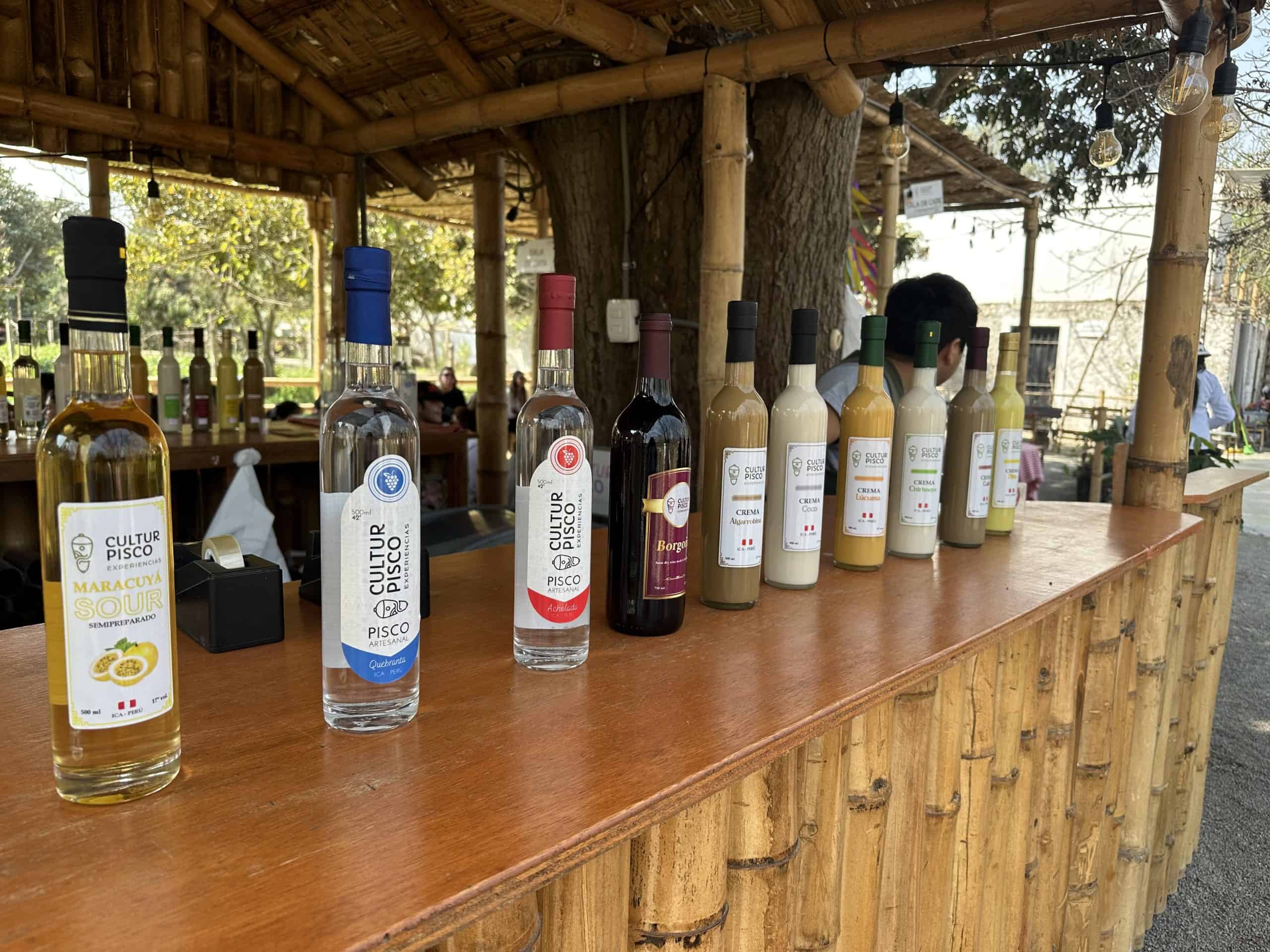 Bottles of Pisco lined up on a bar at a vineyard in Peru.