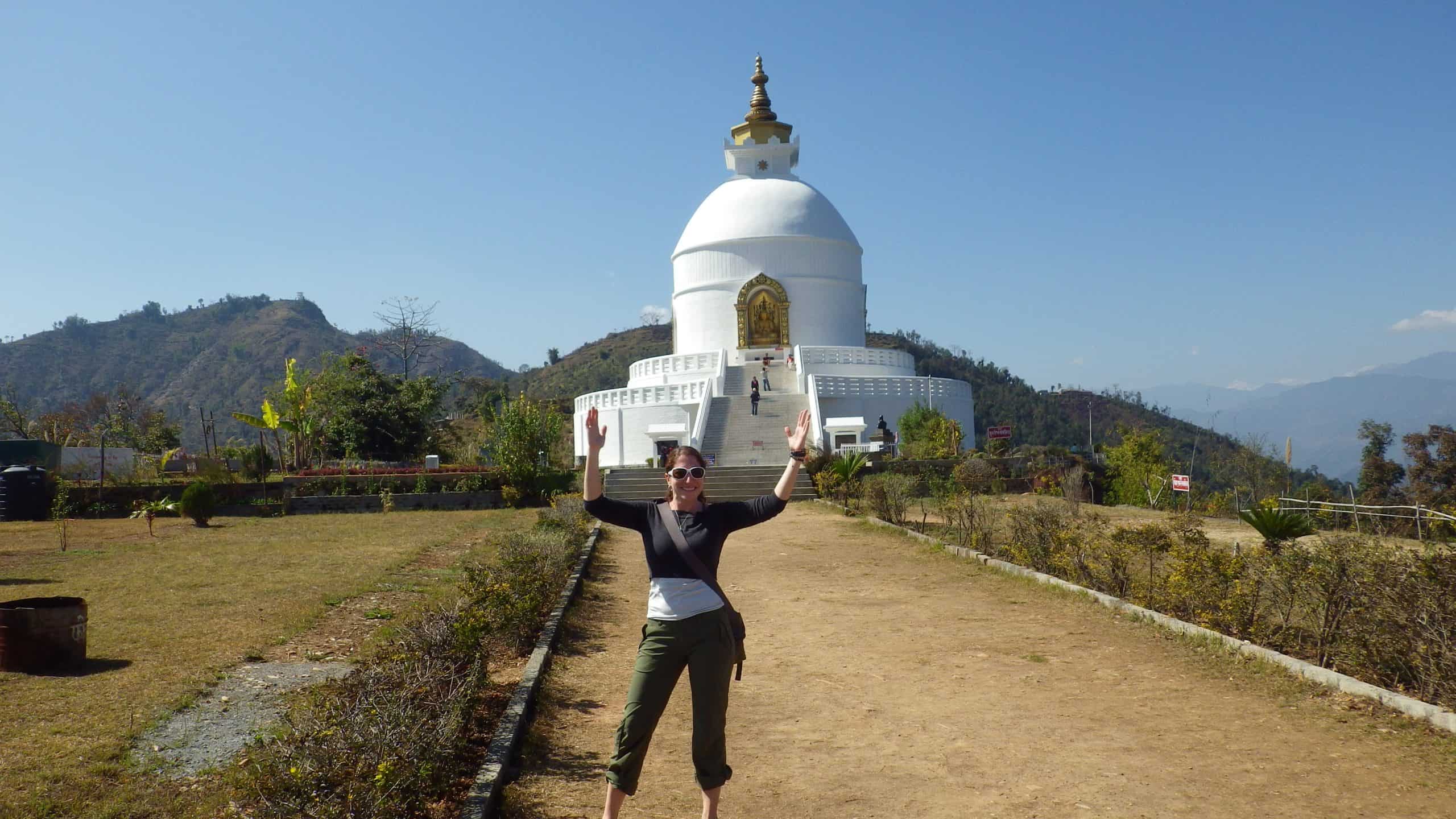 Trekker poses at the World Peace Pagoda outside of Pokhara in Nepal.