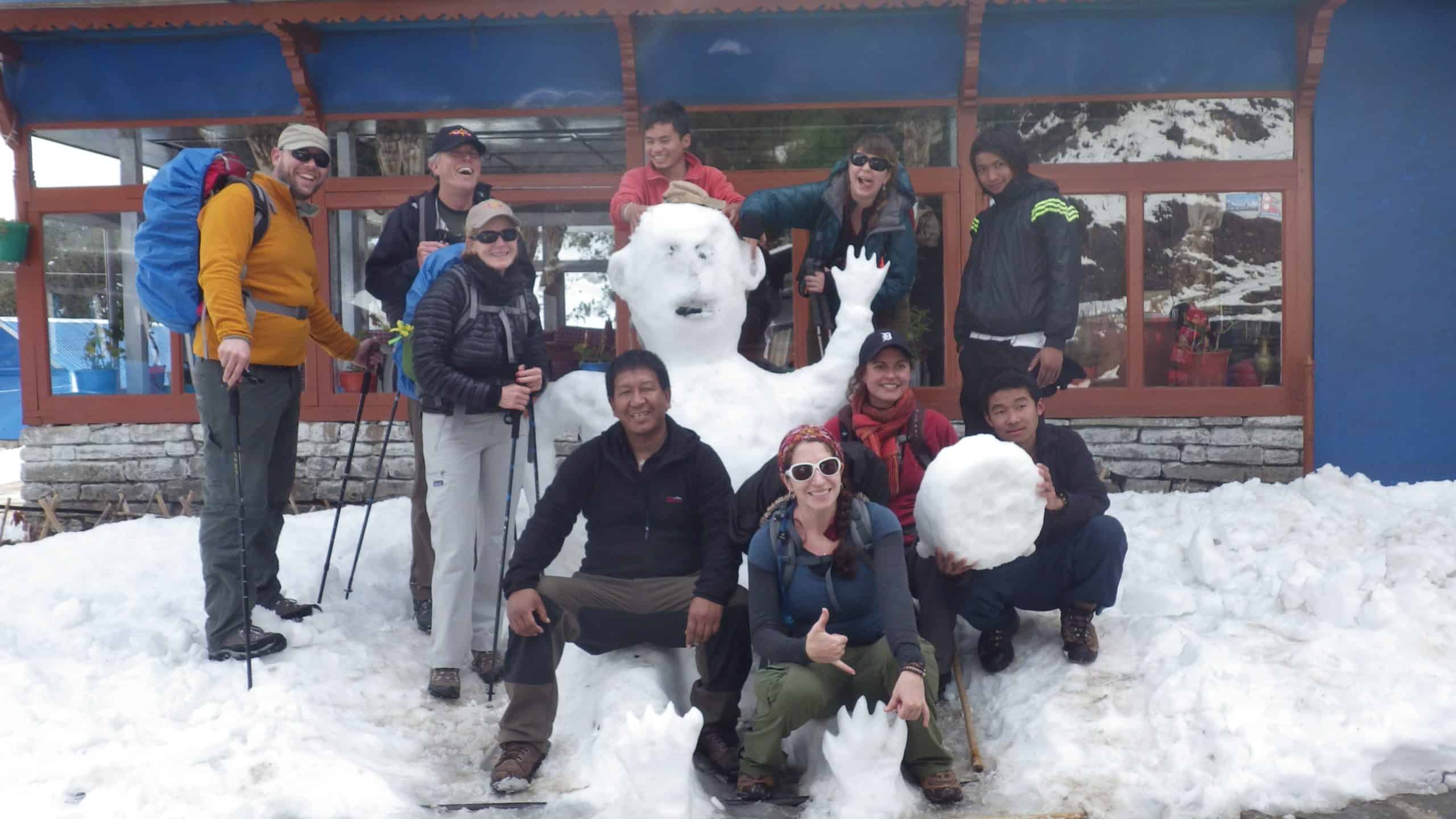 Trekking group posing with a snowman along the Annapurna Circuit.