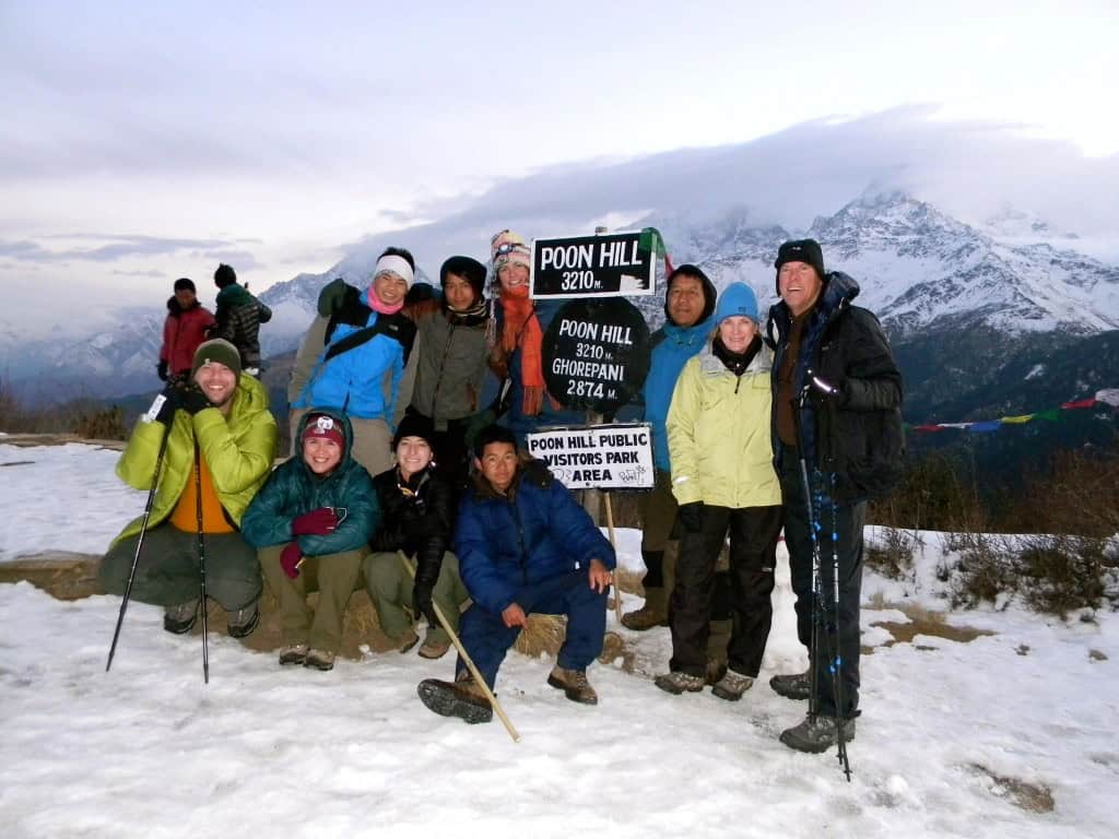 Triumphant trekkers pose at the top of Poon Hill, the highest point of their Annapurna Circuit trek.