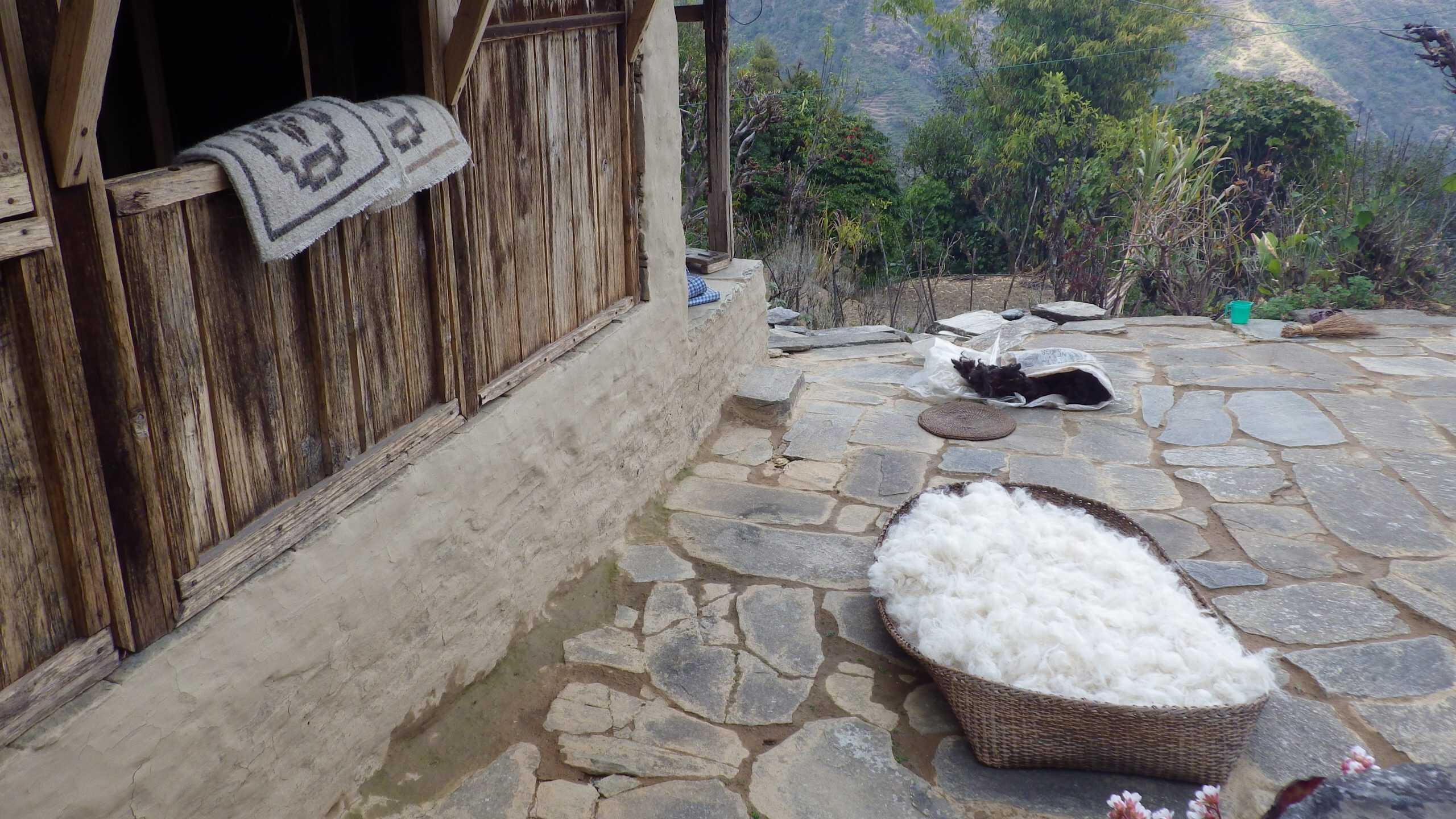 A basket of wool sits by a tradition mountain home along the Annapurna Circuit.