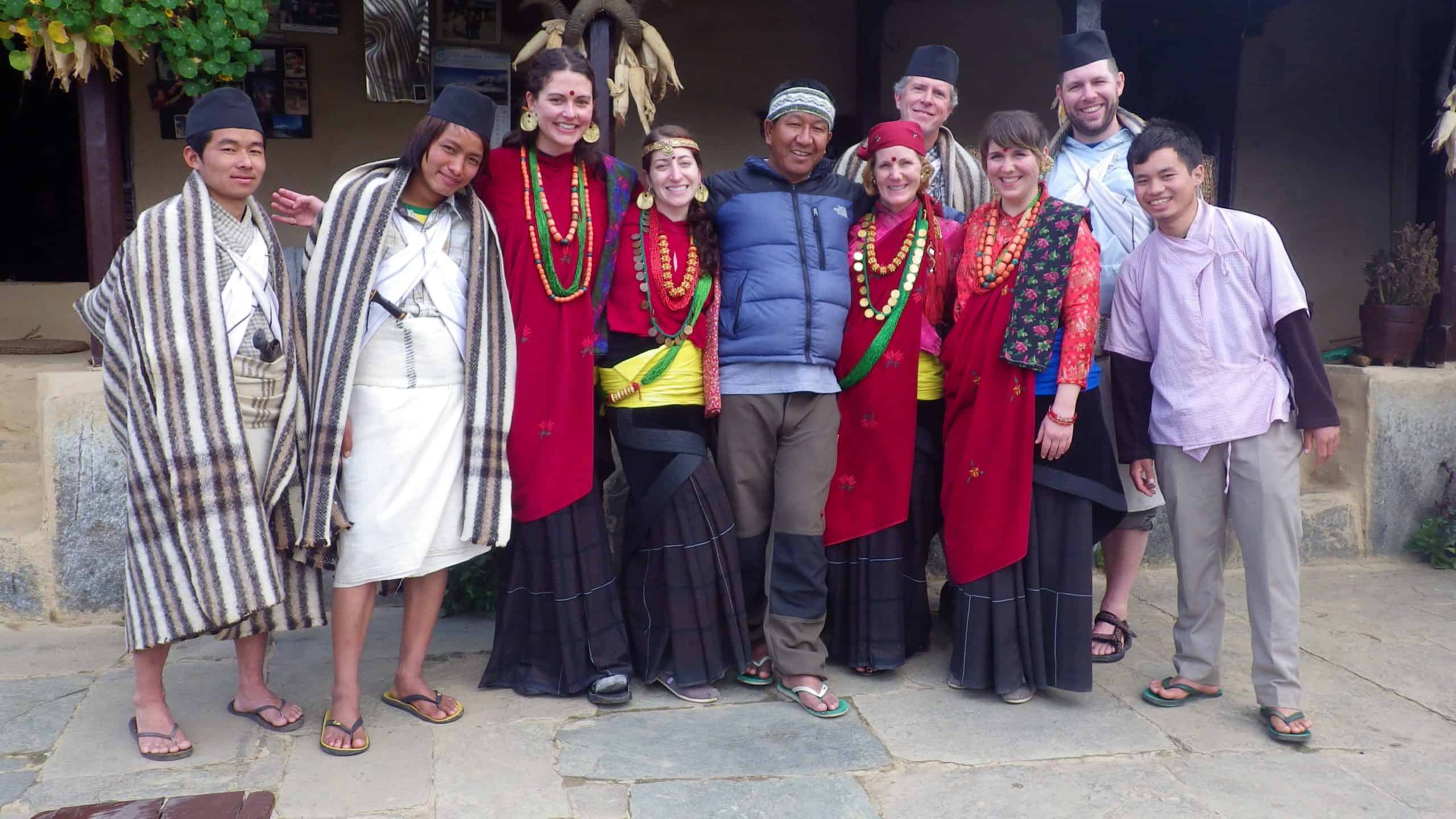 Trekkers and guides dress in traditional clothing along the Annapurna Circuit trail.
