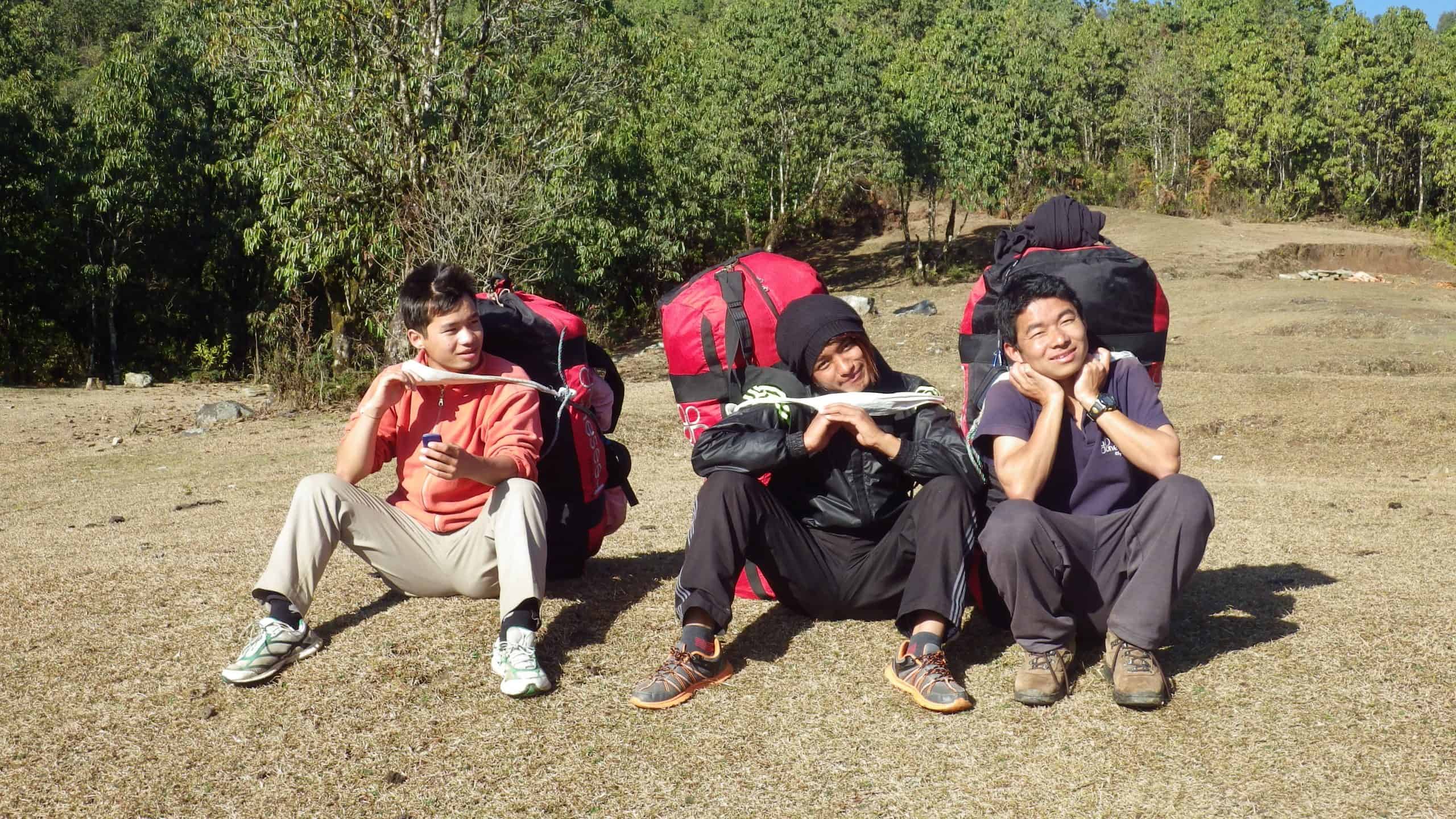 Three porters rest on the Annapurna Circuit trail.