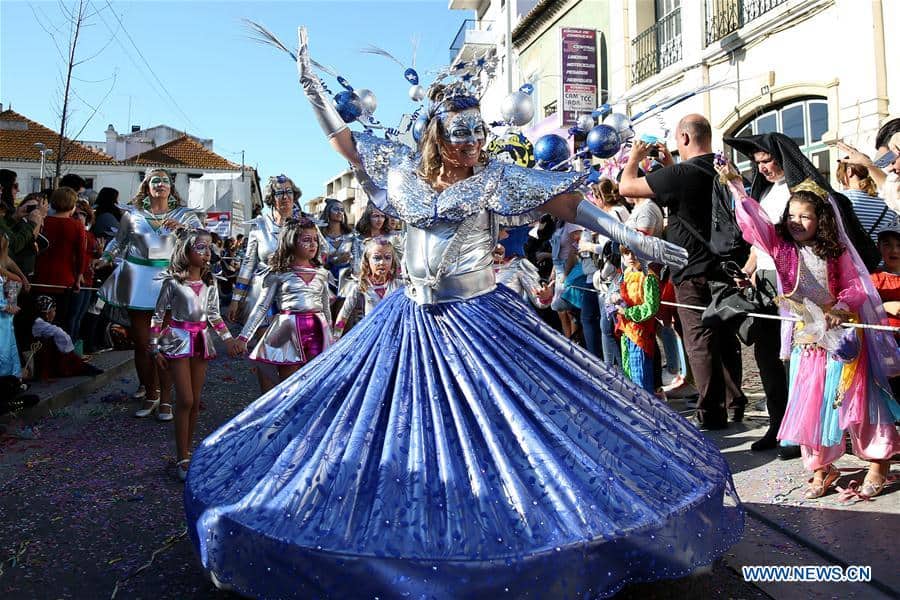 Dancer parades through the streets in Portugal for Carnival celebration.
