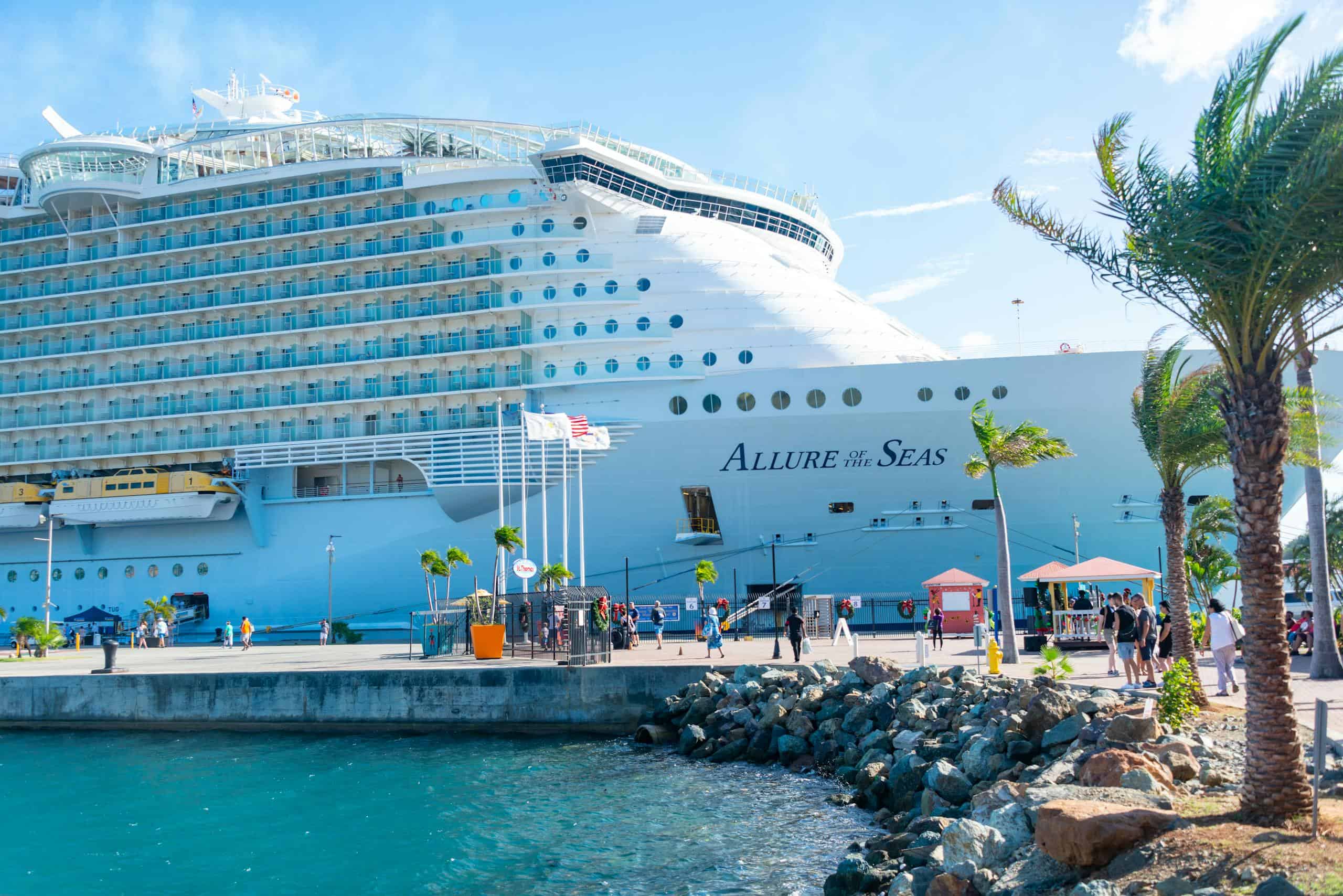 The majestic Allure of the Seas docked in a vibrant Eastern Caribbean port.