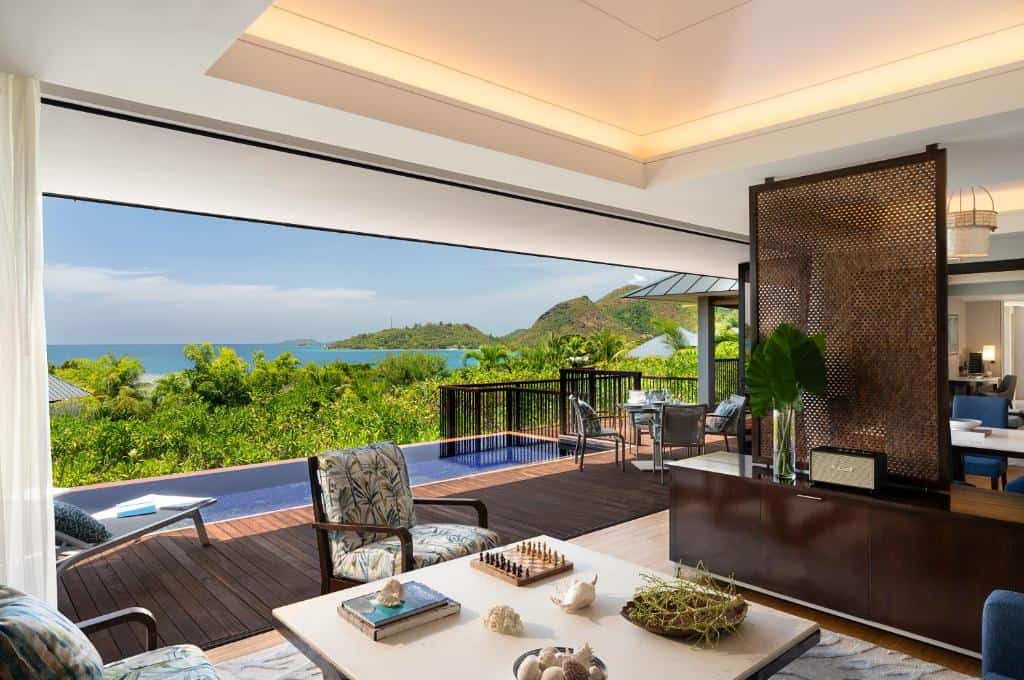 View from inside a luxury villa overlooking a stunning beach at the Raffles Resort in the Seychelles.
