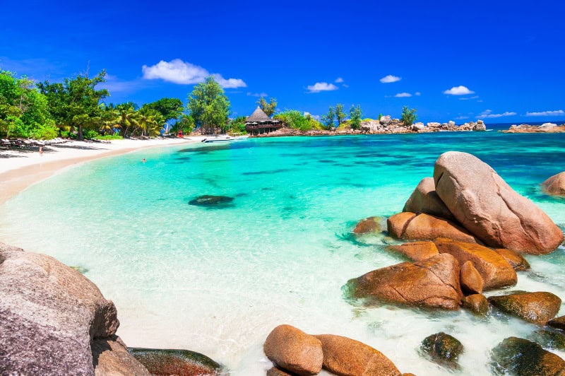 A beautiful white-sand beach with turquoise waters in the Seychelles.