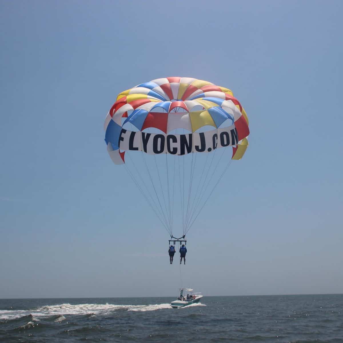Two visitors parasail along the beach in Ocean City, NJ.