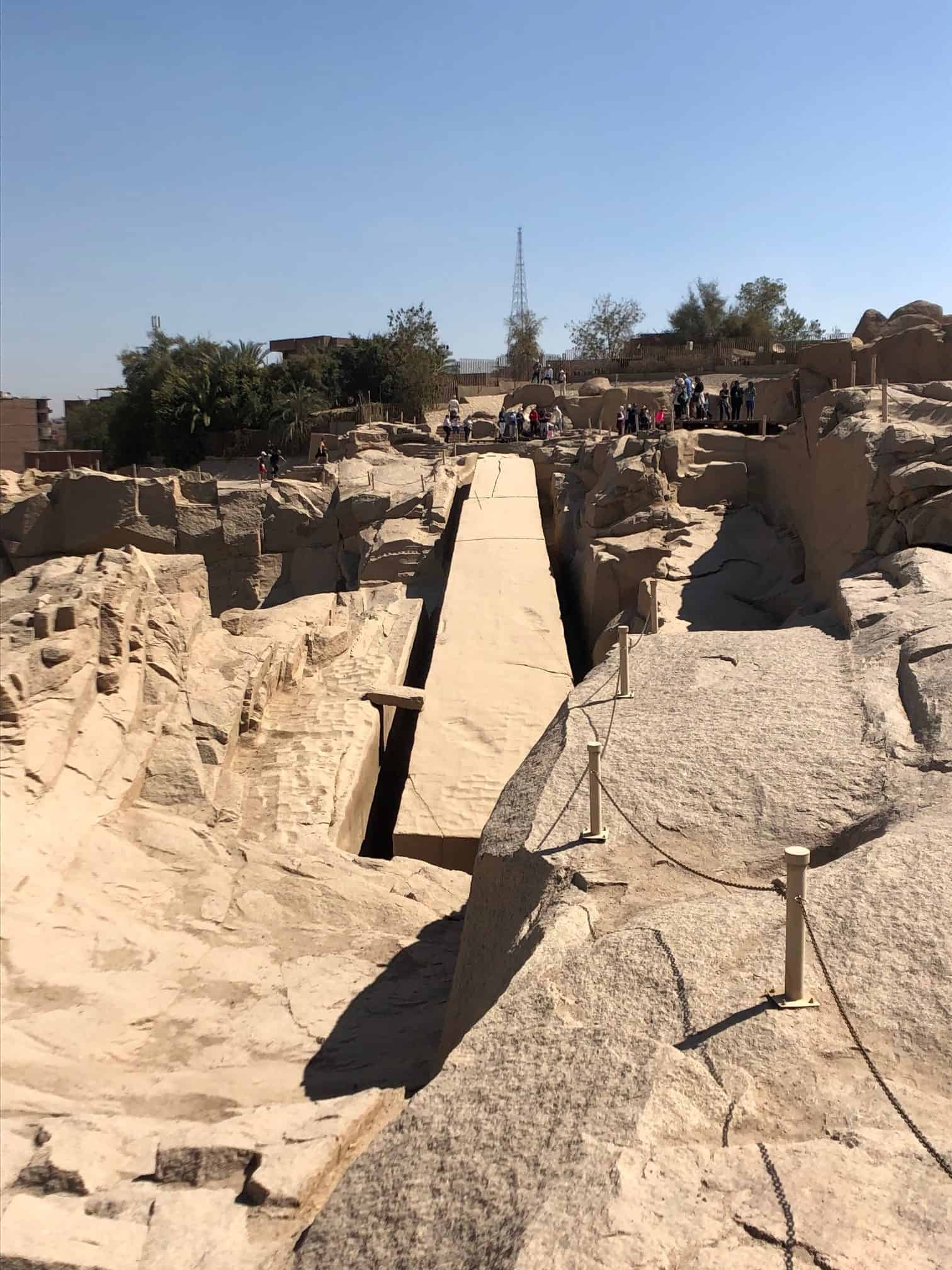 The unfinished obelisk lying cracked and half carved in the quarry in Egypt.