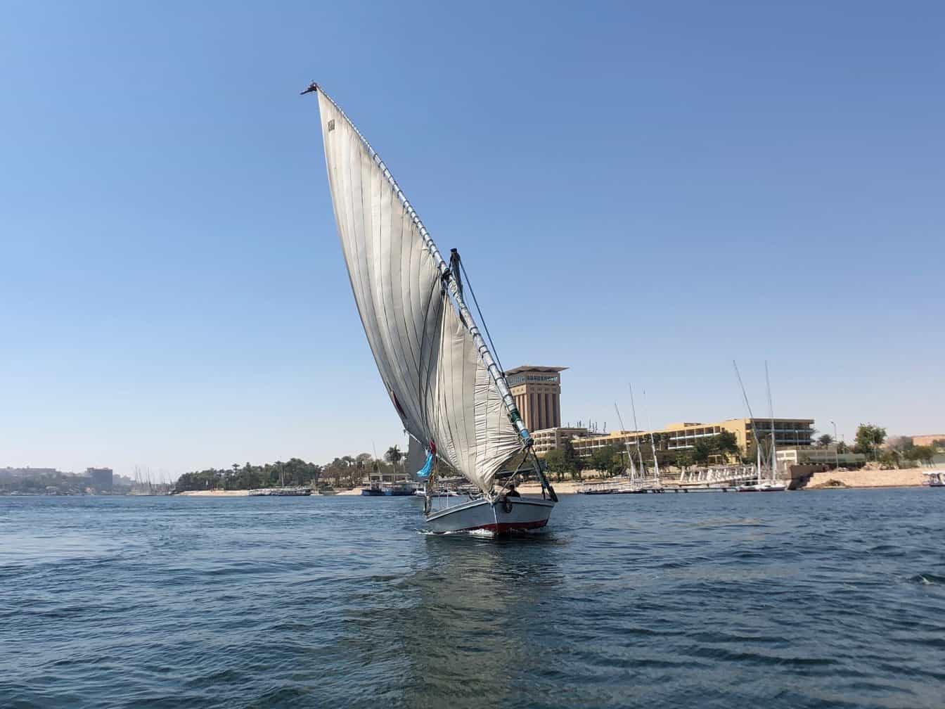 An Egyptian sailboat called a Felucca glides across a lake in Egypt.