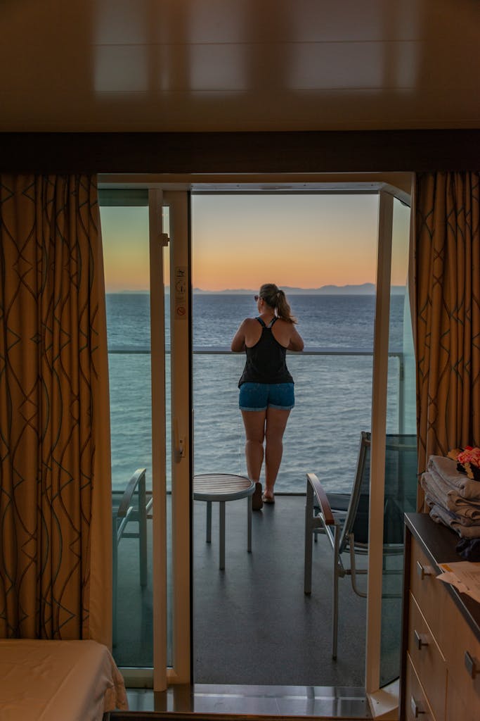 Enjoying a serene sea view from a luxury suite balcony at sunset, capturing a moment of relaxation.