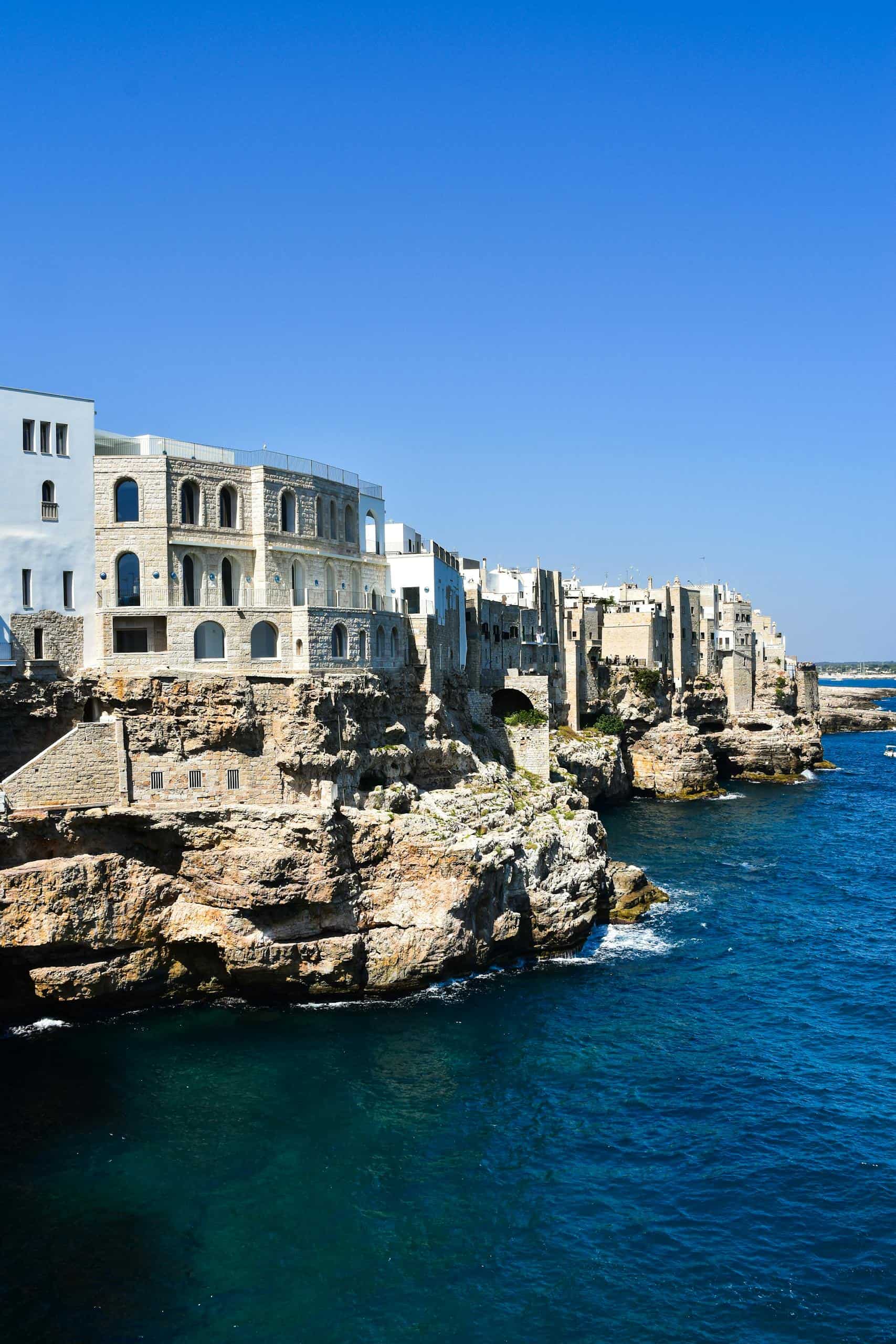 Scenic view of historic architecture perched on cliffs along the Adriatic Sea in Polignano a Mare, Italy.