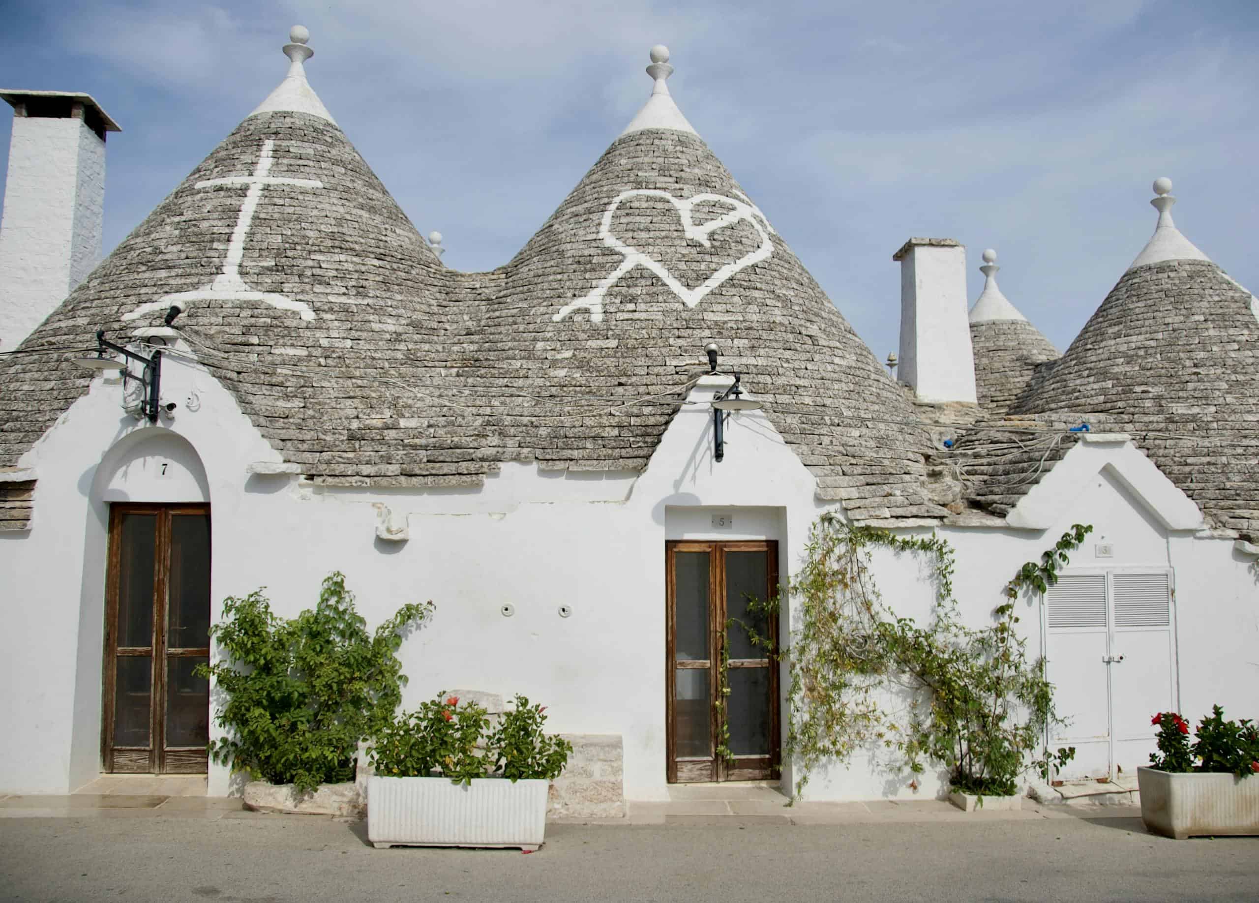 Beautiful Trulli houses with conical roofs in Alberobello, Italy. Iconic whitewashed architecture.