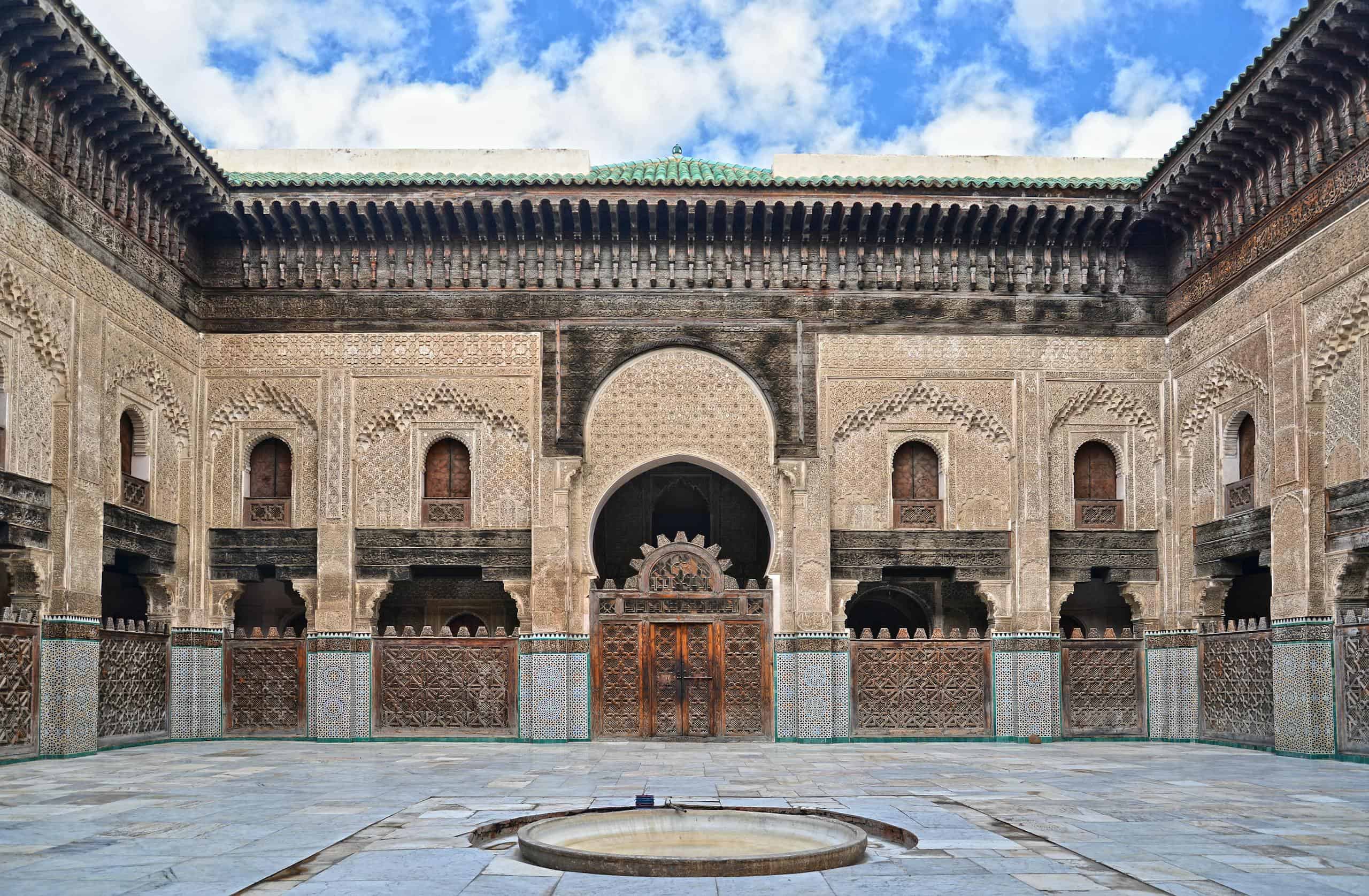 Capture of the ornate courtyard of Bou Inania Madrasa in Fรจs, showcasing beautiful Islamic architecture.