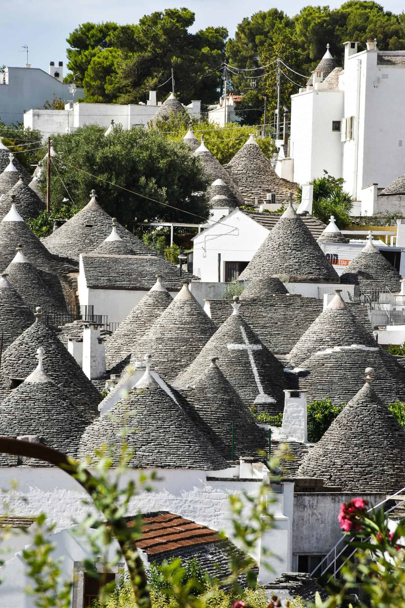 Charming view of unique trulli houses with conical roofs in Alberobello, Italy.