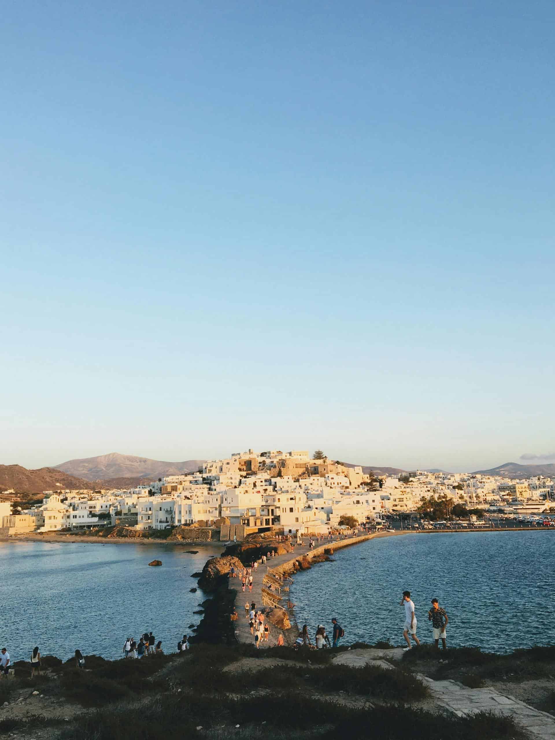 Stunning aerial view of Naxos Old Town with its historic architecture and serene sea at sunset.