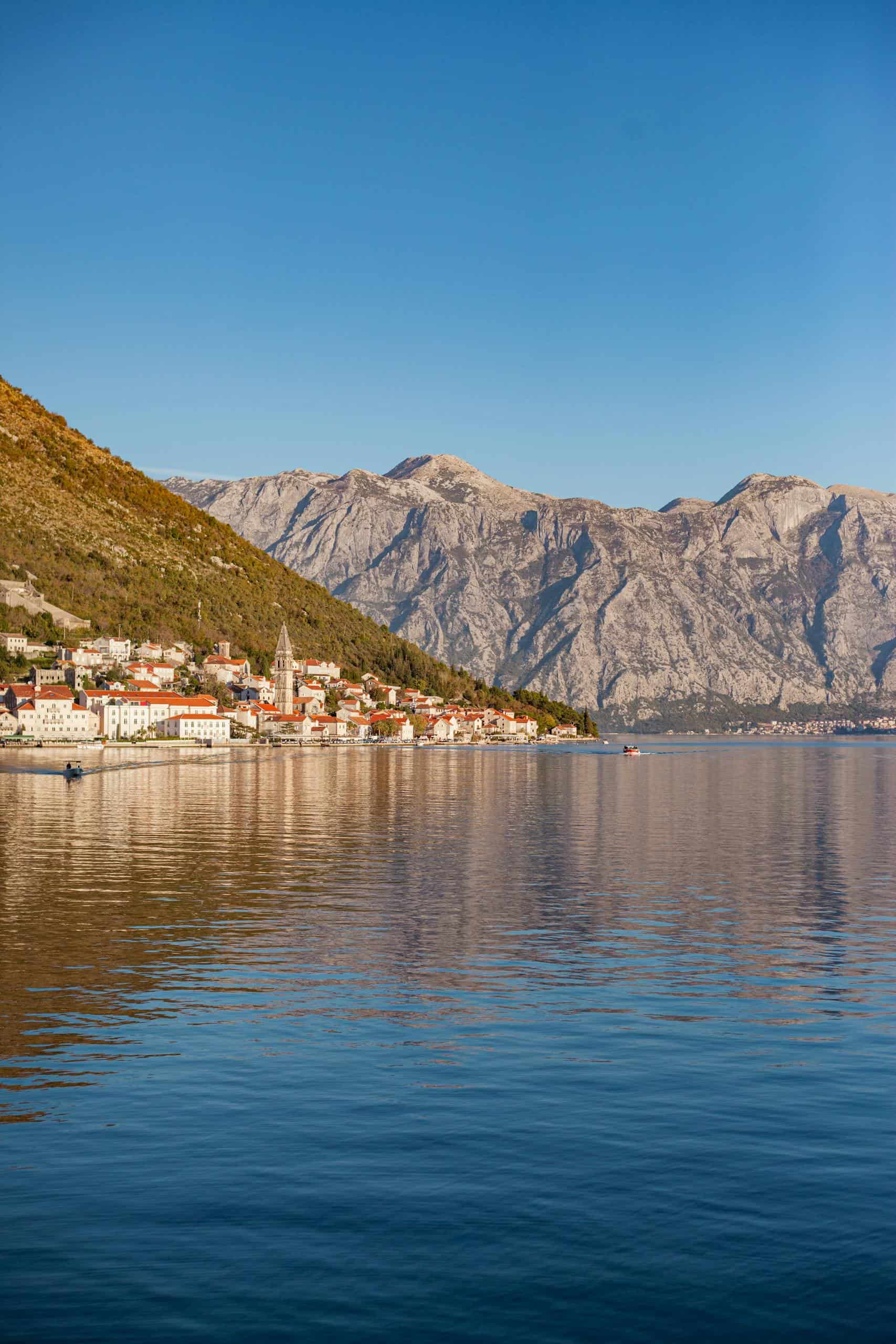 Stunning view of a Montenegro coastal town against majestic mountains.