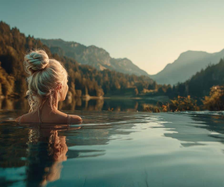 Woman in a hot tub gazing towards the San Juan mountain range.