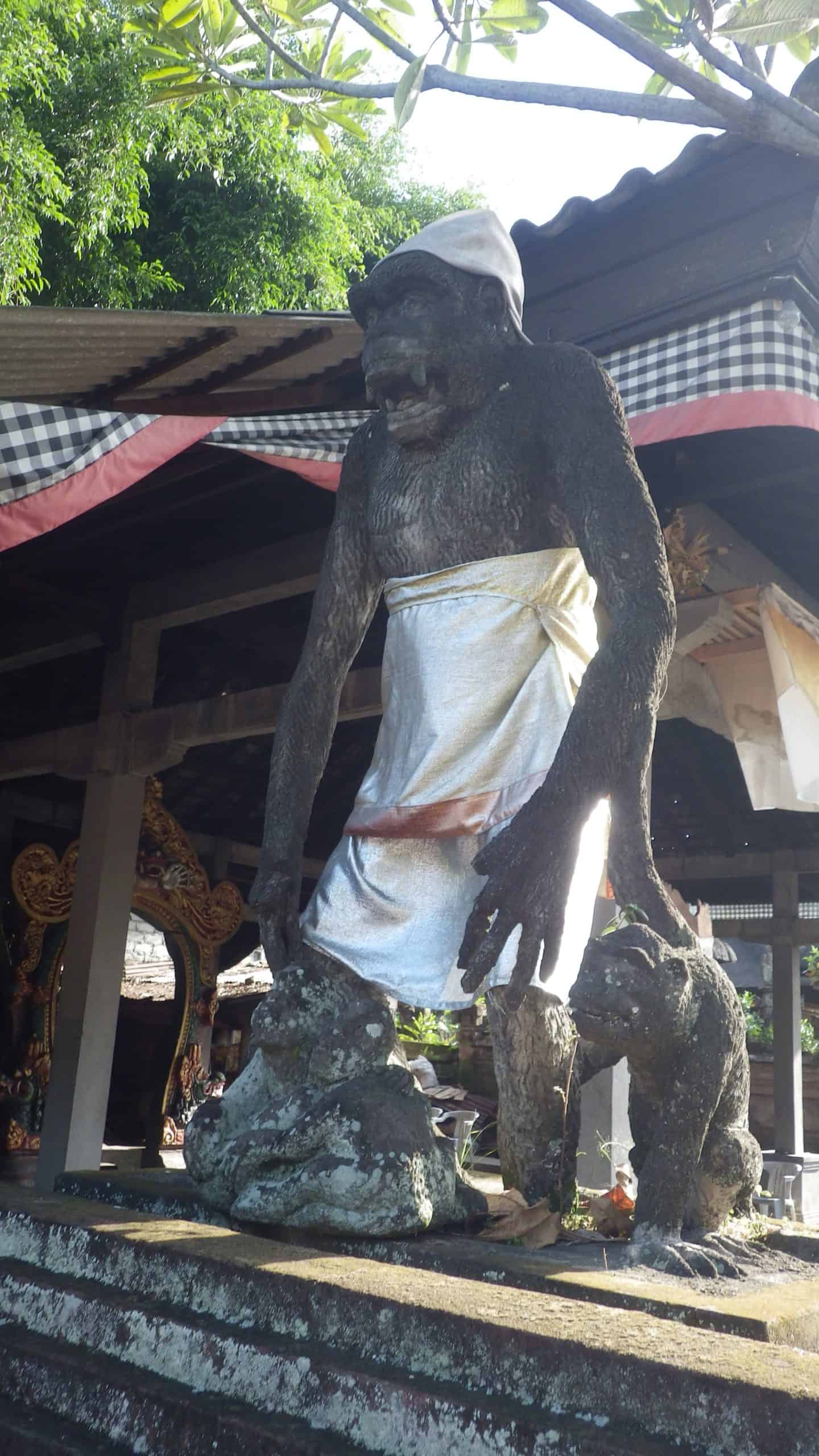 A dressed ape statue in Bali, signifying spiritual importance.