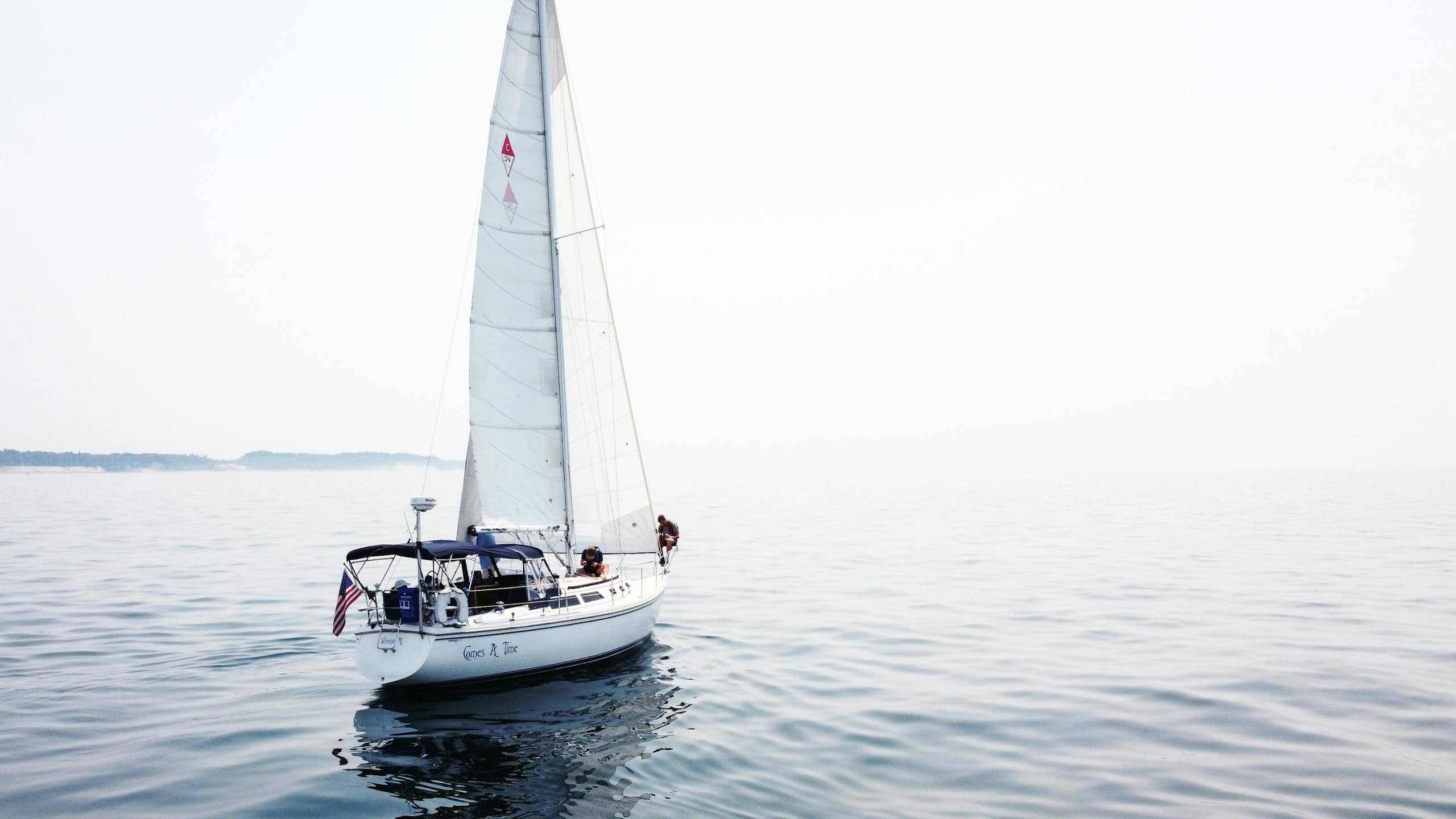 A serene view of a sailboat on Lake Michigan, showcasing a peaceful boating adventure.