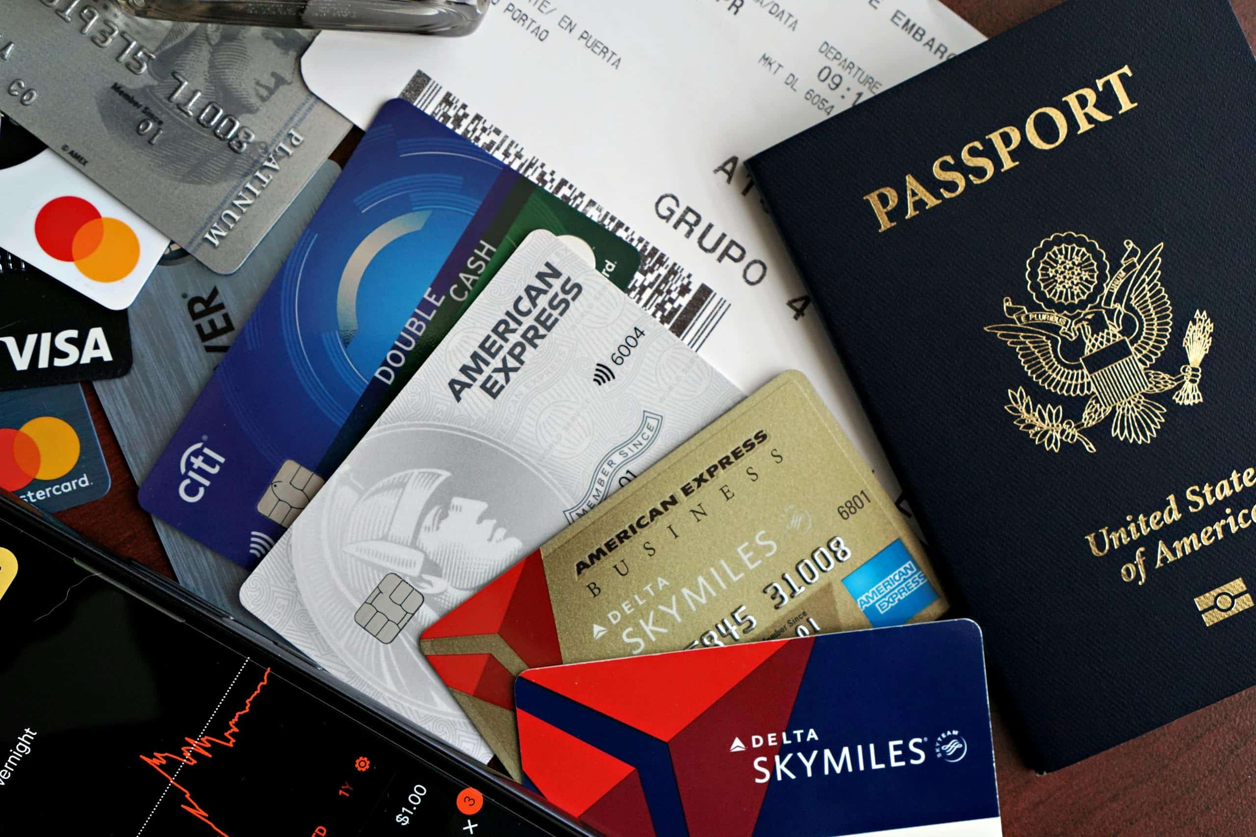 A collection of travel essentials including a passport, credit cards, and a boarding pass. Ideal for travel and finance concepts.