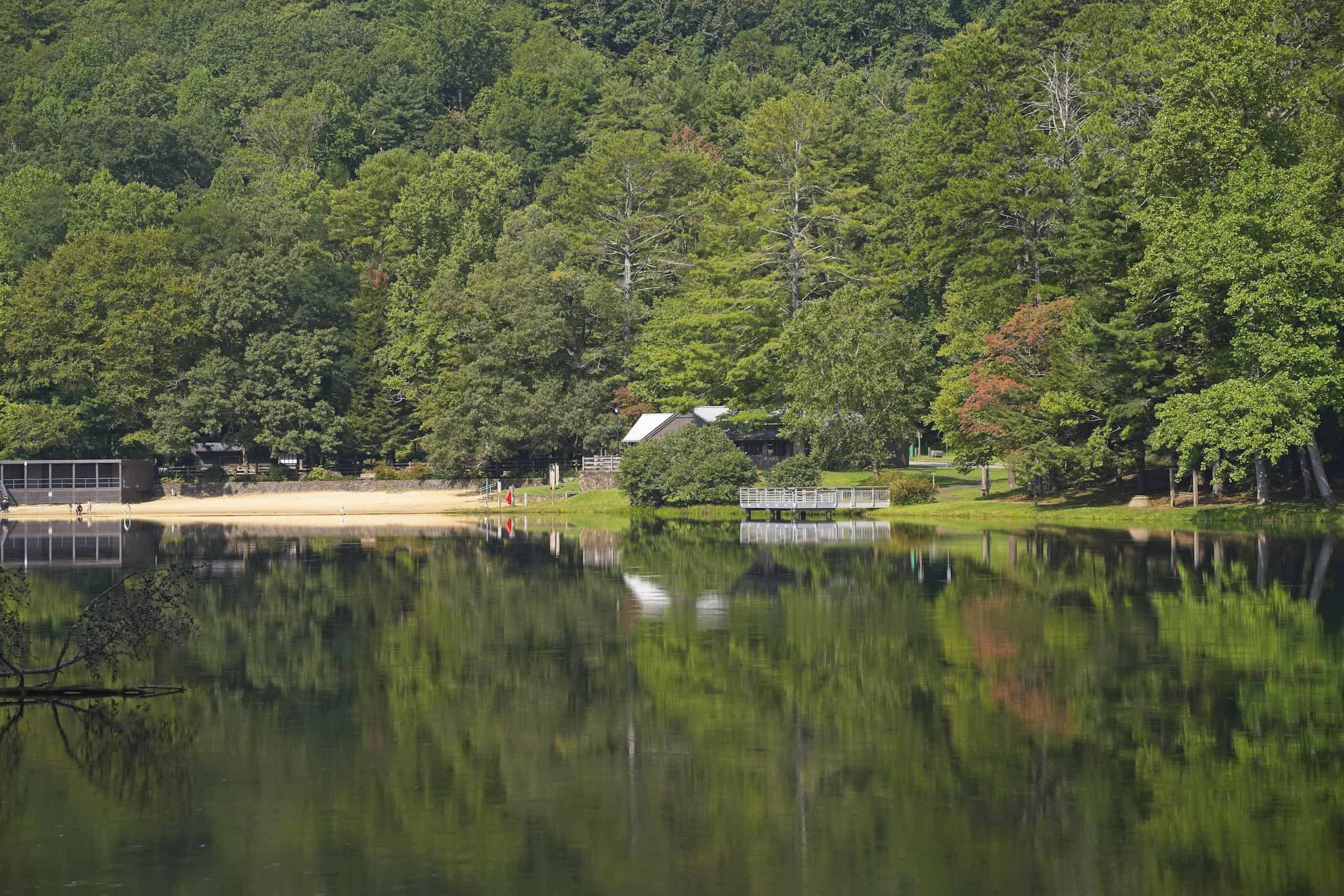 Beautiful lake reflection surrounded by lush forest in Vogel State Park, Blairsville, GA.