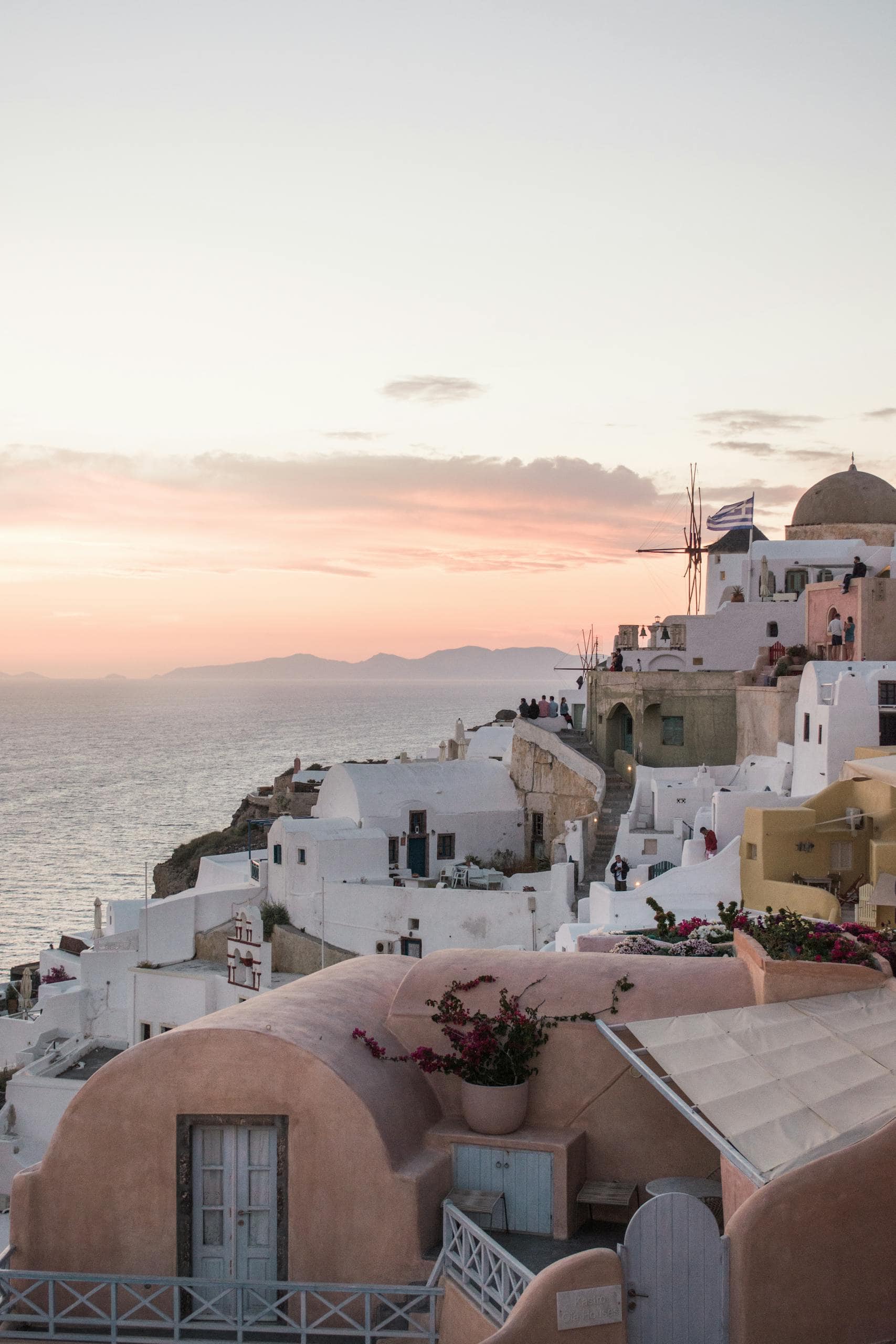 Captivating view of Santorini's iconic architecture and Aegean Sea at sunset.