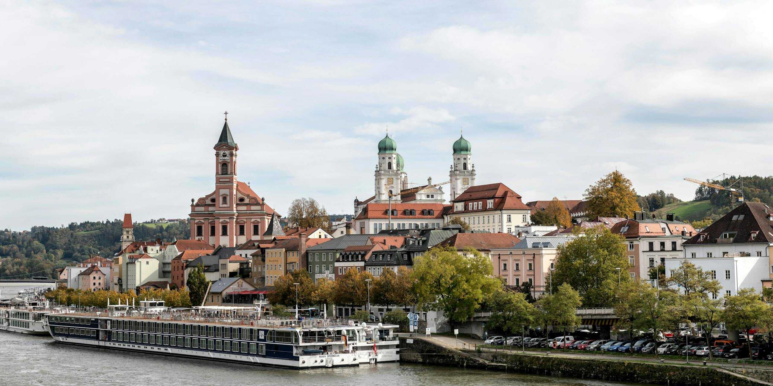 Panoramic view of Passau's old town and churches along the Danube River.