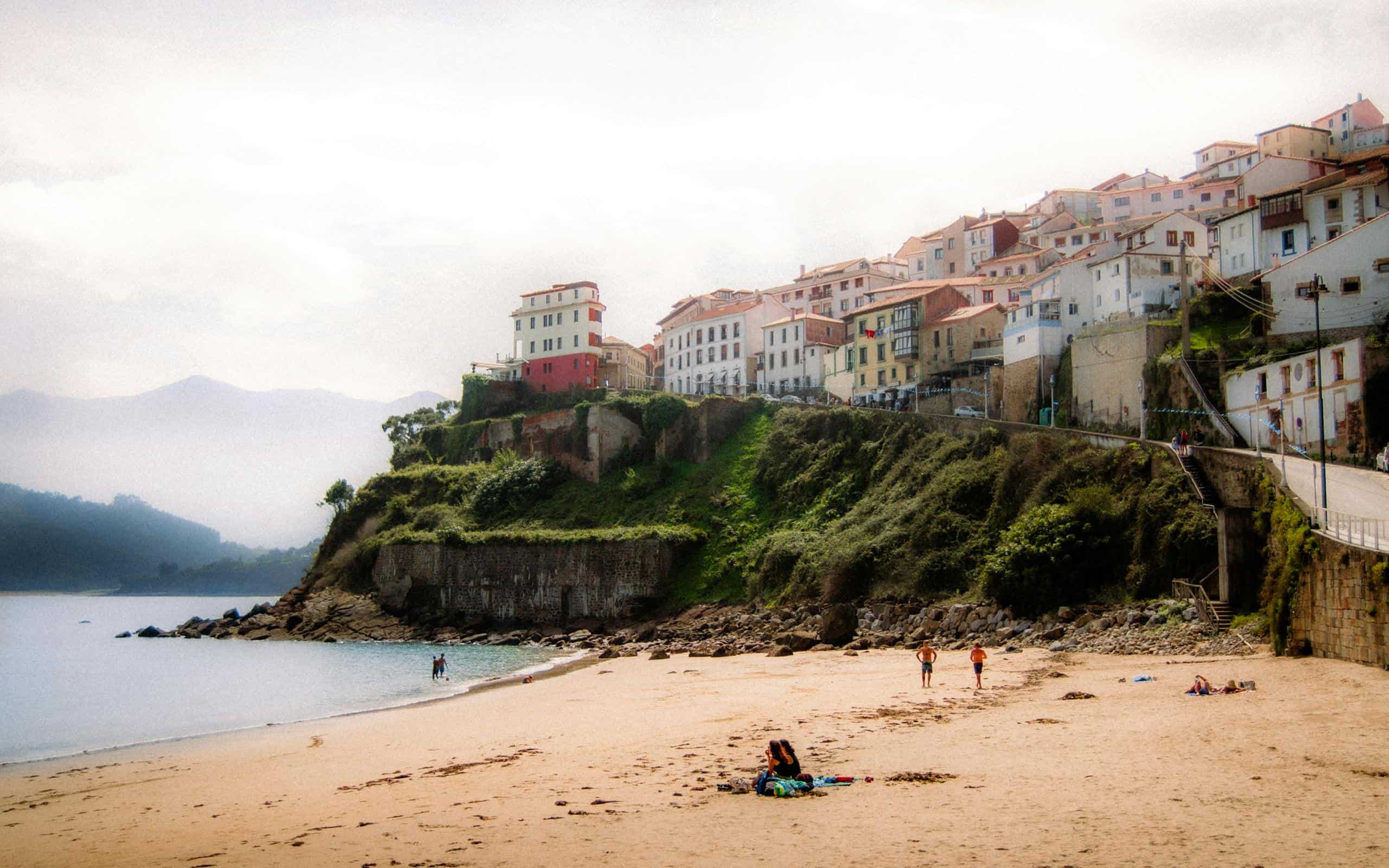 Picturesque beach and clifftop village setting in Asturias, Spain.