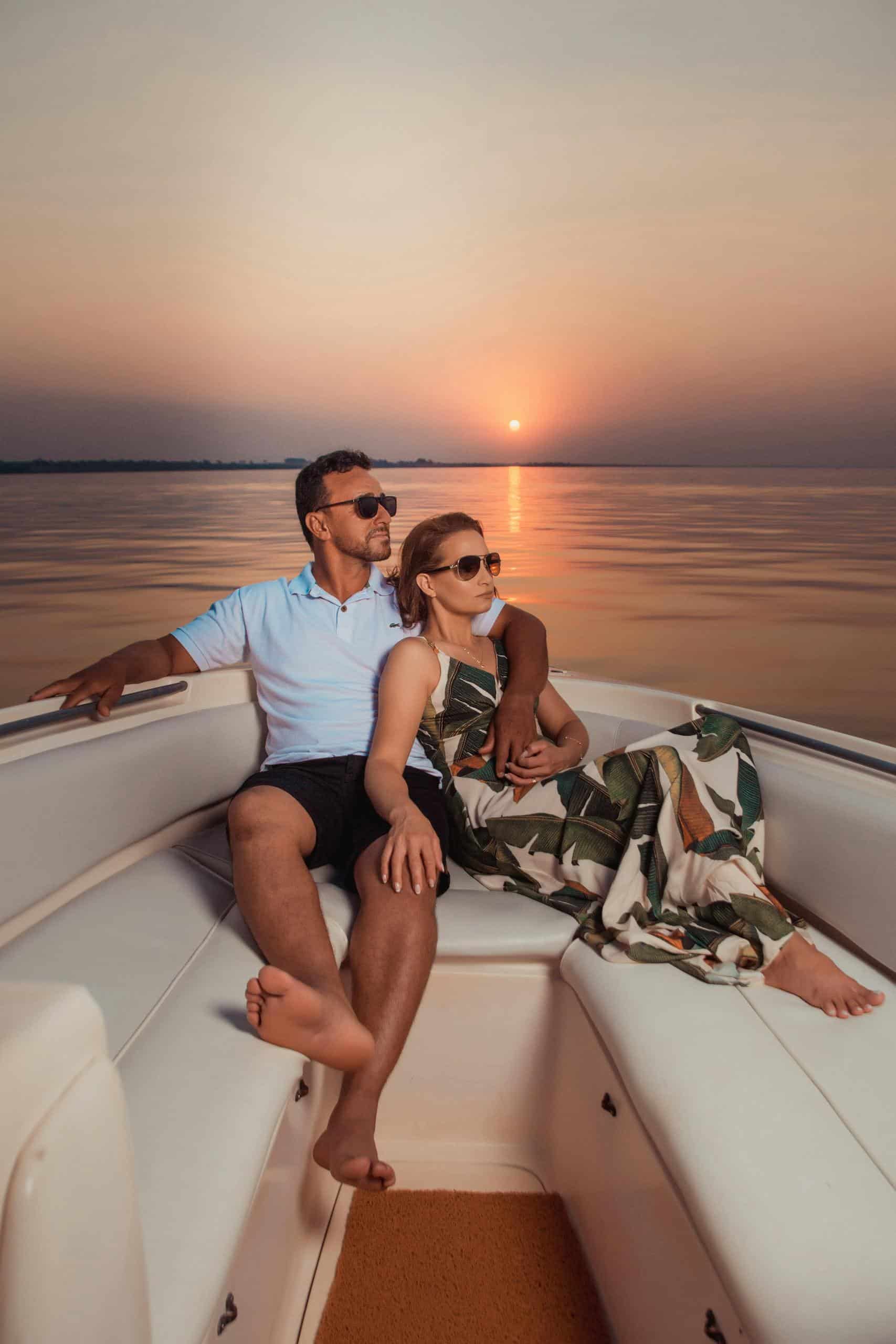 Couple looking polished and wrinkle-free, enjoying a peaceful sunset together on a cruise.